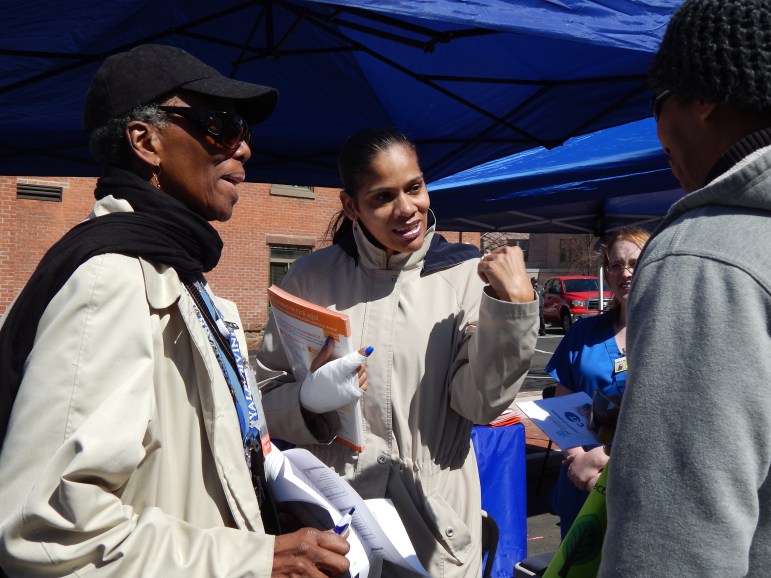 The Rev. Shirle Moone Childs, left, and Rebecca Santiago talk about insurance and doctor visits at a Hartford health fair earlier this year.