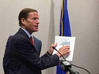 U.S. Sen. Richard Blumenthal criticizing airline fees at a press conference Tuesday.