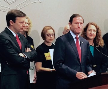 Sen. Richard Blumenthal, at podium, is joined by Sen. Chris Murphy, left, and U.S. Rep Elizabeth Esty, D-5th District, speak to the press Monday about the waiting period for federal background checks on gun purchasers.