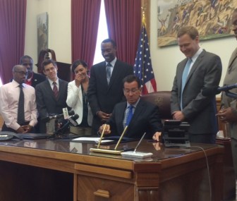 Gov. Dannel P. Malloy, flanked by Doug Glanville, left. and Rep. Matter Ritter.