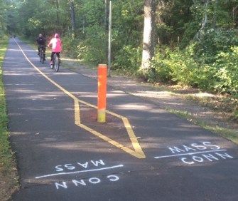 Bicyclists cross the state line from Suffield into Massachusetts last weekend.