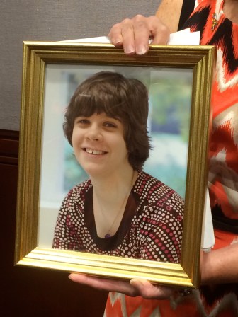 Michelle RIvelli holding a portrait of Jessie.