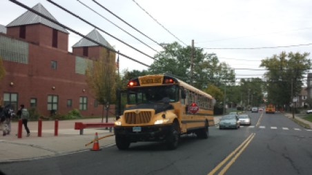 A school bus drops off students at a school in the south end of Hartford