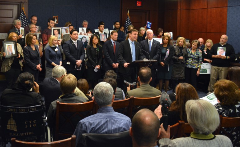 U.S. Sens. Richard Blumenthal and Chris Murphy, at podium, House Minority Leader Nancy Pelosi, standing far left, other congressional Democrats and family members of victims of gun violence