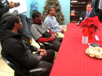 Gov. Malloy talks with three youth at a group home in Hartford for youth in the juvenile justice system.