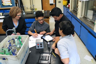 Education Commissioner Dianna Wentzell watches students in a science class at East Hartford Middle School.