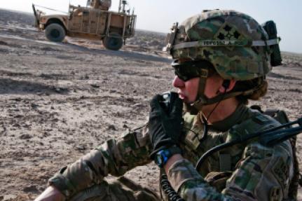 U.S. Army 1st Lt. Elyse Ping Medvigy conducts a call-for-fire during an artillery shoot south of Kandahar Airfield, Afghanistan, in 2014. 