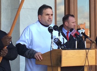 Chuck Della Rocco, president of the union representing judicial and criminal justice security personnel, addresses the crowd.