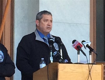 Collin Provost, president of the state correction officer union, speaks.