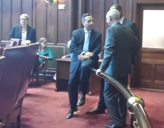 Regents President Mark Ojakian, right, talks with Sen. Bob Duff, Senate majority leader, left, and a member of Gov. Dannel P. Malloy's staff before the debate on making undocumented students eligible for financial aid.