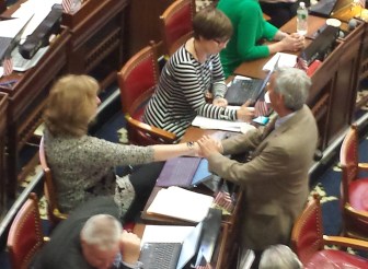 Rep. Cecilia Buck-Taylor, left, is consoled by a colleague after sharing her story.
