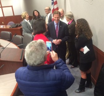 U.S. Sen. Richard Blumenthal poses for pictures after a GMO labeling press conference. At right is Tara Cook-Littman.
