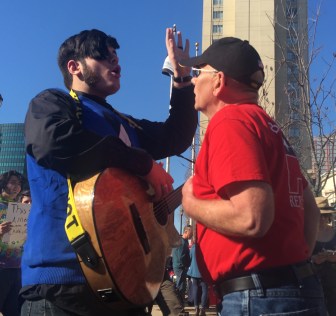 Tunxis Community College student Austin Sullivan, left, debates Bristol resident Clifford Carlson before the rally