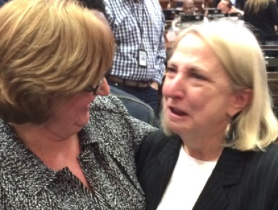 Retiring Rep. Roberta Willis, right, gets a hug from Rep. Cathy Abercrombie after the House voted to rename a scholarship in her honor.