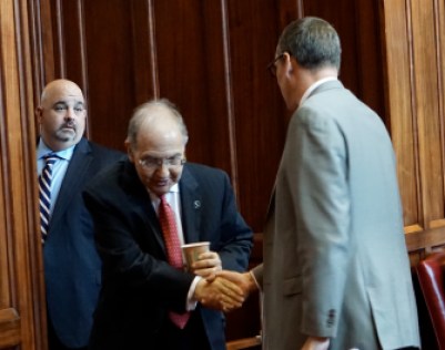 Budget chief Ben Barnes, right, shakes hands with the Senate leader, Martin Looney as debate begins. At Watching is Looney's top aide, Vinnie Mauro.