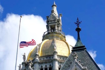 The U.S. flag flies at half staff over the state Capitol in mourning for the deaths in Orlando.
