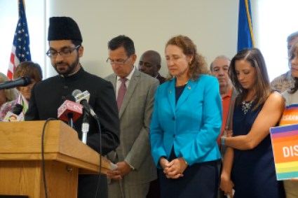 Imam Hamid Nasir Malik leads a prayer. At right are Gov. Dannel P. Malloy, Rep. Elizabeth Esty and Jillian Soto, whose sister was killed at Sandy Hook.