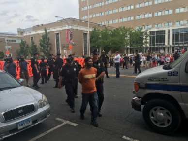Police arrest John Jairo Lugo, a former undocumented immigrant who is now a U.S. citizen, on Main Street in Hartford Monday.