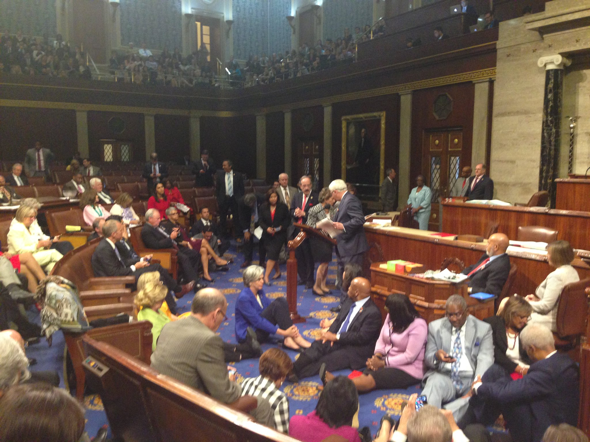 Rep. John Larson at the podium amidst fellow Democrats during the sit-in.