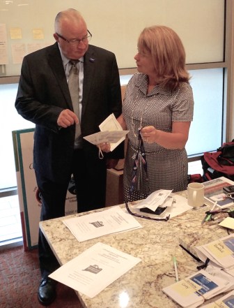 Delegate Charles Bruckerhoff of Chaplin picks up his credentials from alternate Catherine Marx.