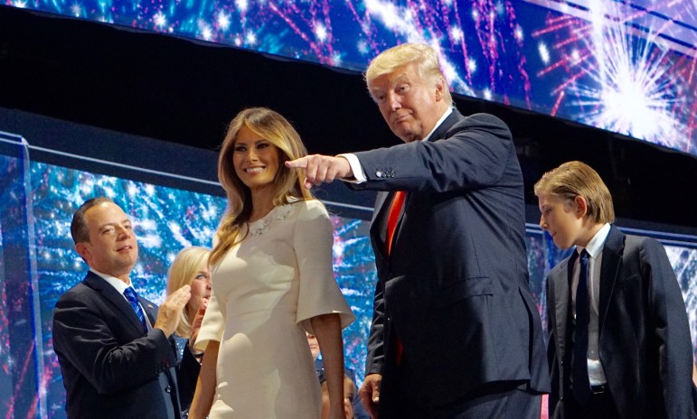 Donald J. Trump exits the stage with his wife, Melania, trailed by their son. At left is RNC chairman Reince Priebus.