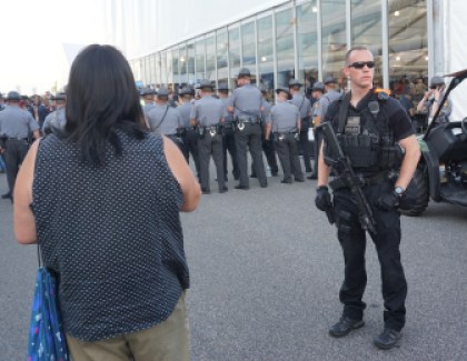 Sanders delegates protest outside the DNC as police watch.