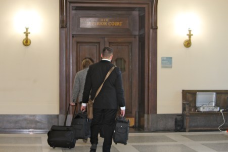 Attorneys suing the state enter the court for the last day of the trial.