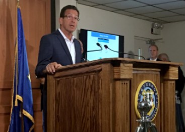 Gov. Dannel P. Malloy answers questions from reporters at the State Armory Tuesday morning.