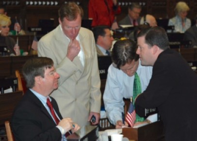 Ward, seated at left, strategizes during a House session.
