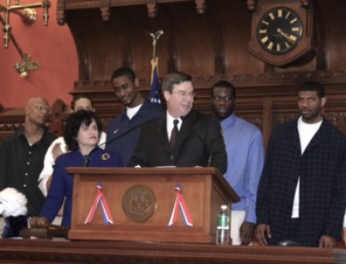 Ward at the House podium with Moira Lyons at left