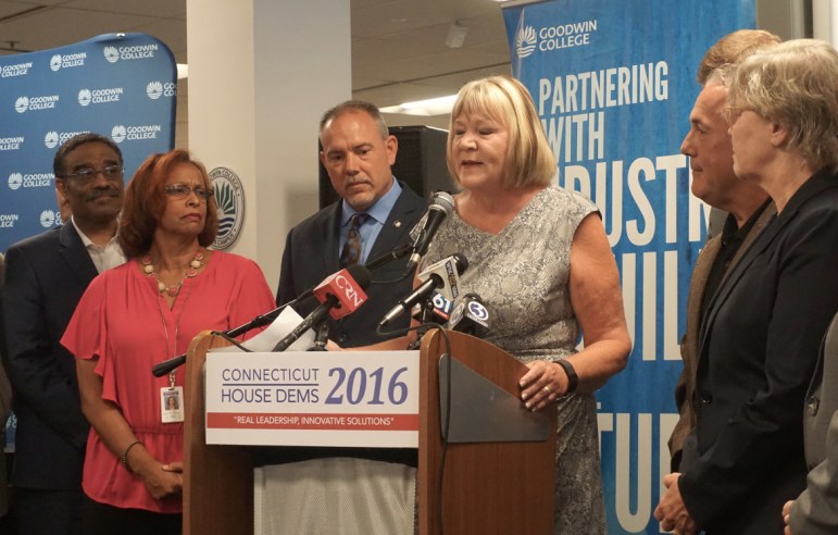 Rep. Theresa Conroy was featured. She is targeted for defeat this fall. At left is House Majority Leader Joe Aresimowicz.