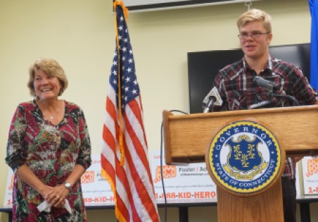 Kathy Coale laughs as her nephew, Avery, thanks their DCF social worker, Adam Texeira.