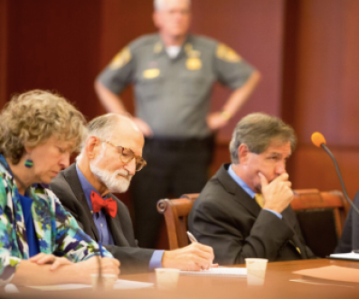 Associate Attorney General Joseph Rubin, center, and Joseph Moodhe, lead counsel for the plaintiffs, as Moukawsher read his decision.
