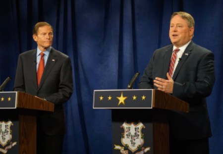 Blumenthal listens as Carter jabs.