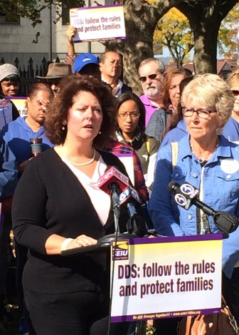 Jane Vasseur, of Enfield, whose adult brother is a group in Simsbury that is slated for privatization, addresses the union rally outside the Superior Court in Hartford.