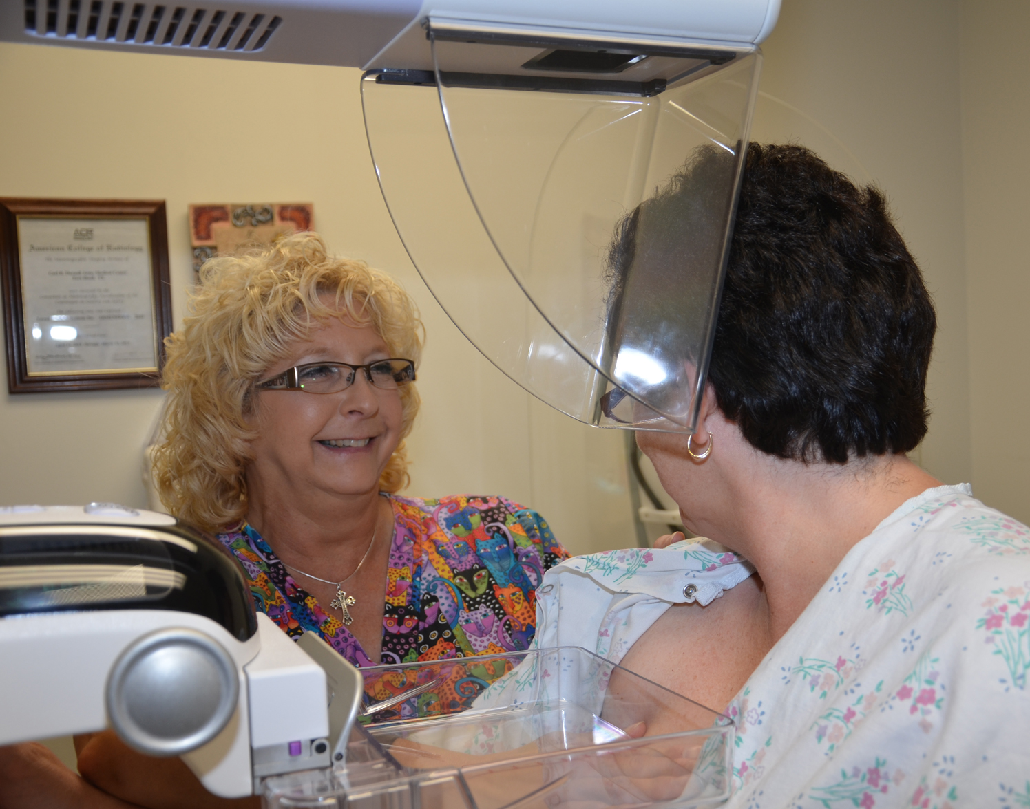 Teresa Ropbitaille, CRDAMC mammography technician, prepares a patient for a mammogram.