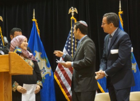 Rabbi Joshua Ratner and Gov. Dannel P. Malloy greet Abir, a Syrian refugee.