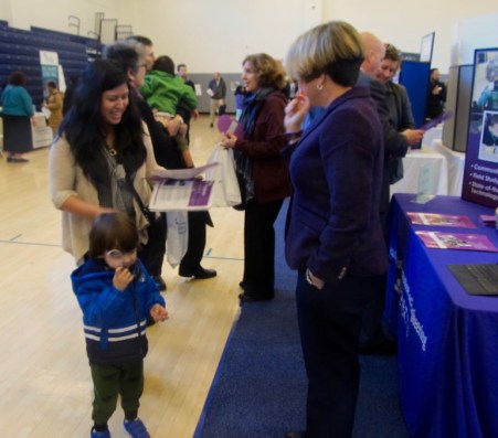 Violet Ork with her son in tow talk with Gayle Hills, the principal of Academy of Aerospace and Engineering Elementary School.