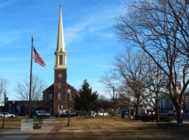 The Old Stone Church stands over the East Haven town green on a windy weekday in January.
