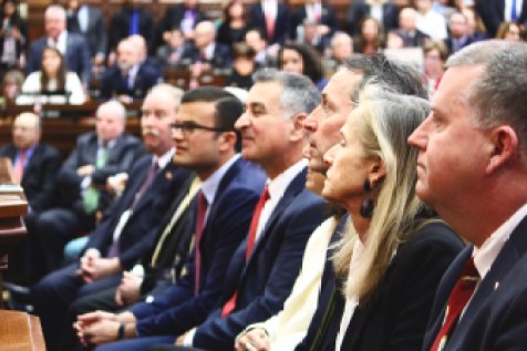 State Senators watch as the governor delivers his State of the State Speech