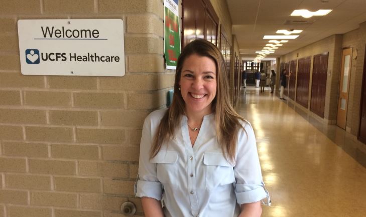Julia Cooper, who supervises school-based health centers for United Family & Community Services, outside the clinic at Kelly Middle School.