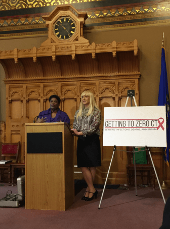 Latoya Tyson and Dr. A.C. Demidont, members of the Getting to Zero Commission speaking at the state capitol building Monday.