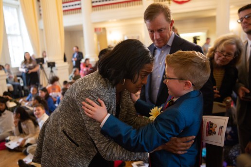 Ella is congratulated by U.S. Rep. Jahana Hayes, a former National Teacher of the Year, as Gov. Ned Lamont looks on.