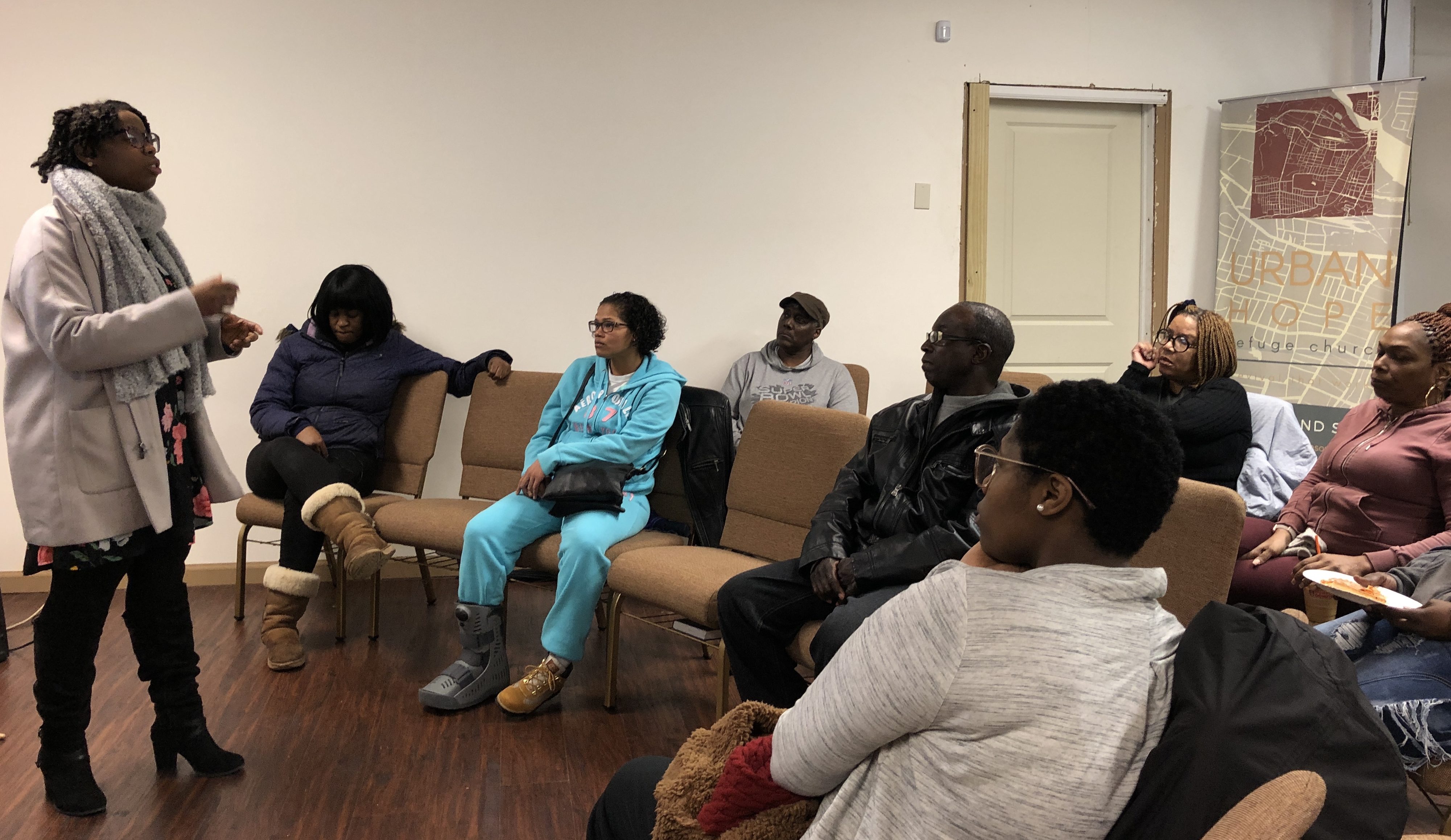 Community organizer Tieasha Gayle speaks to Barbour Gardens tenants at a meeting on Tuesday