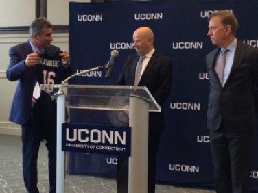 Uconn president-designate Tom Katsouleas accepts a UConn jersey from Uconn Board of Trustees President Tom Kruger and Gov. Ned Lamont