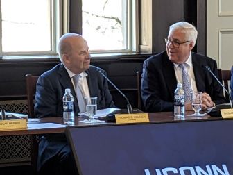 Tom Ritter, vice chairman of the UConn trustees, praises Tom Kruger, outgoing president of the board. Kruger resigned from the board after Wednesday's meeting.