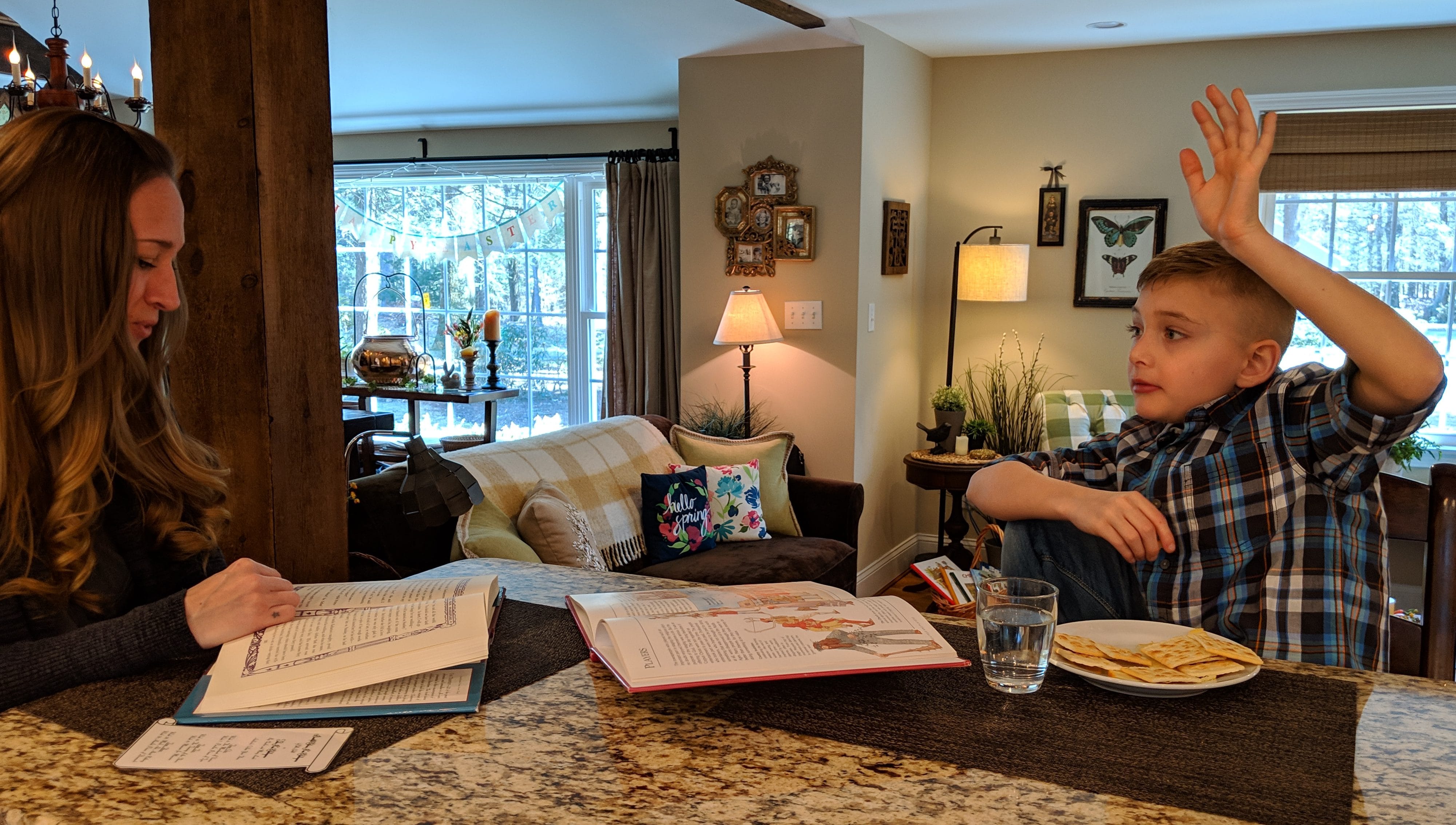 Tucker Schlotter has a question for his mother, Lina, as she reads to him from Shakespeare's "Taming of the Shrew" during a homeschooling lesson recently.