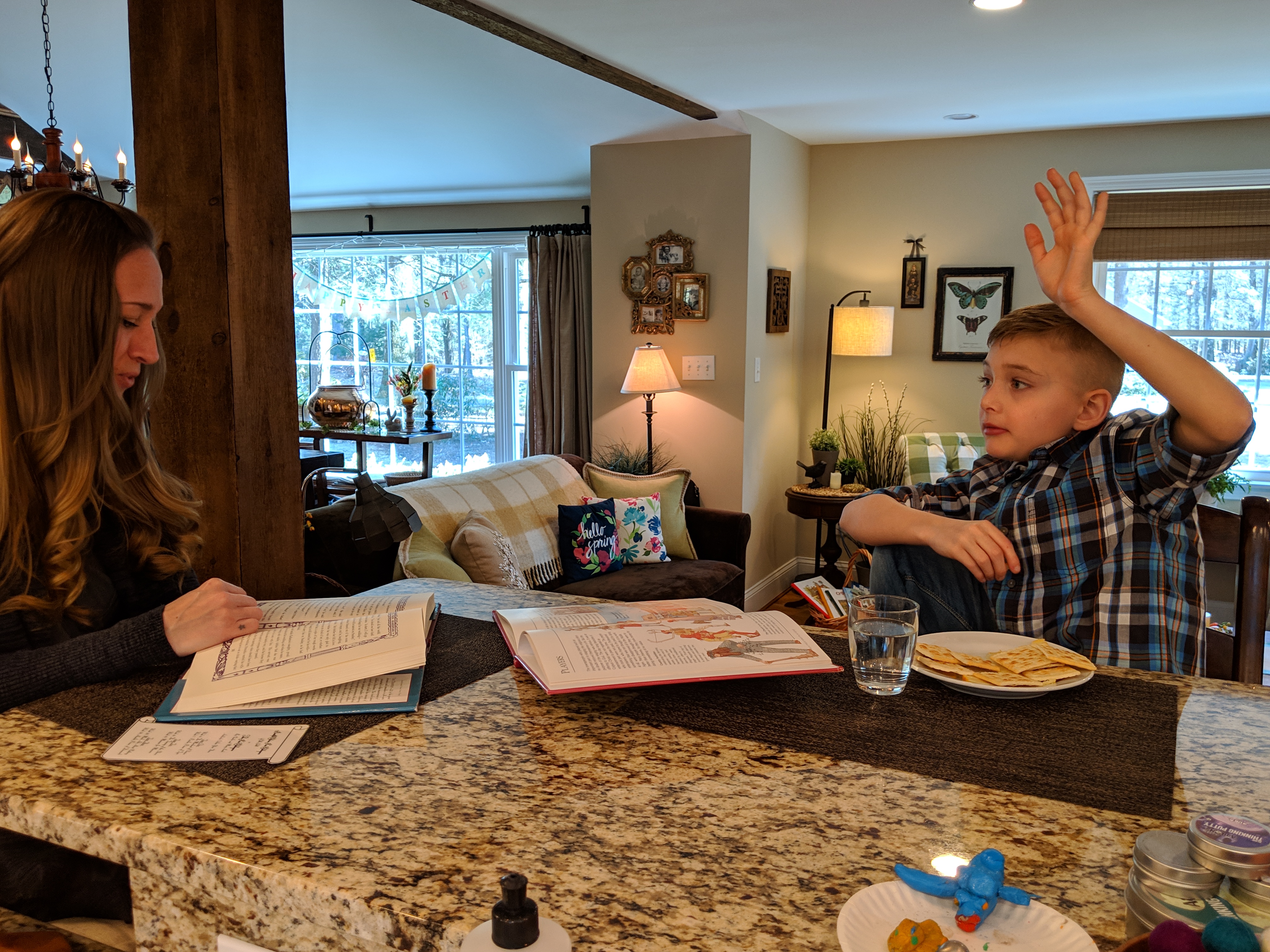 Tucker Schlotter has a question for his mother, Lina, as she reads to him from Shakespeare's "Taming of the Shrew" during a homeschooling lesson recently.