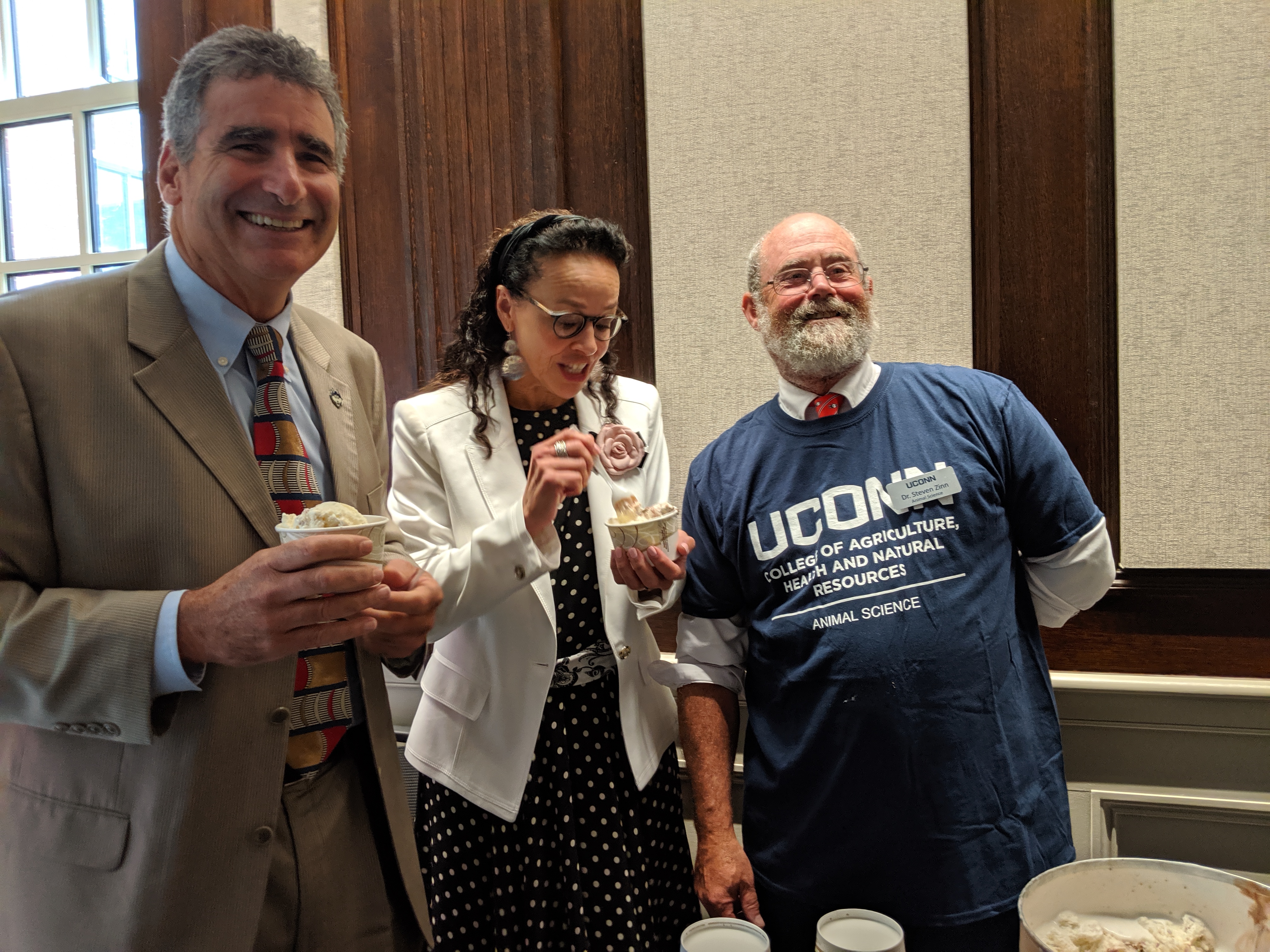 During a break in Wednesday's trustee meeting, UConn's new president, Tom Katsouleas, left, enjoys lemon icebox ice cream from the UConn Dairy with UConn board member, Andrea Dennis-LaVigne, and Prof. Steven A. Zinn, head of Animal Science Department. Katsouleas and the trustees were treated to the ice cream which was recently named the best from a university by the American Society of Animal Science.