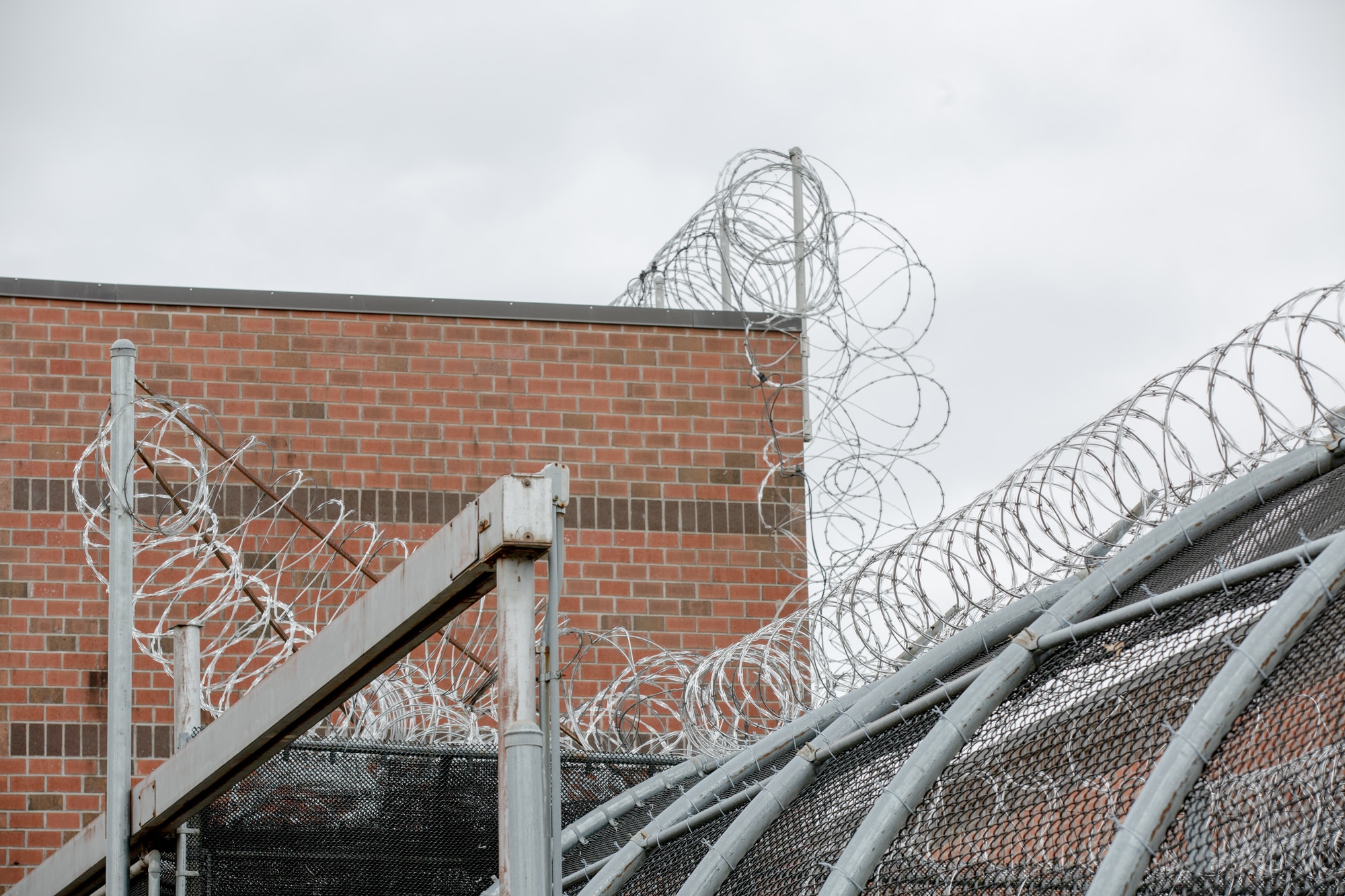 A fence topped with barbed wire at MacDougall-Walker Correctional.